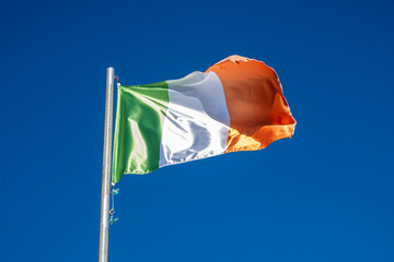 a flag of Ireland fluttering in the wind