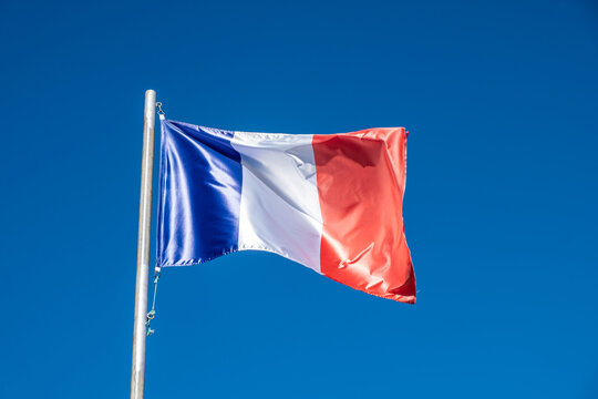 a French flag waving in the wind