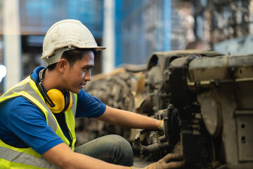 Engineer male worker check inventory store old used auto spare part engine gear part list for sale...