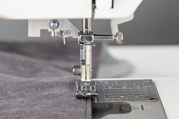 Sewing machine, stitching fabrics, needle in a round plan