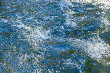 flow of water and spray from a stone