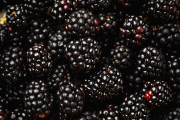 Ripe blackberry on the dark rustic background. Selective focus. Shallow depth of field.