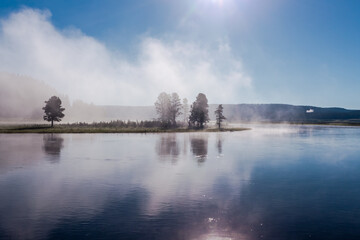 Beautiful foggy landscape of the river in morning mist and light. Wyoming, Yellowstone National Park