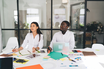 Multiethnic colleagues working in creative office during meeting