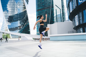 Active woman doing warmup exercise in street