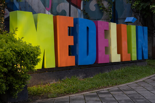 Colorful lit decorative sign Medellin in the tourist part of the city El Poblado.
