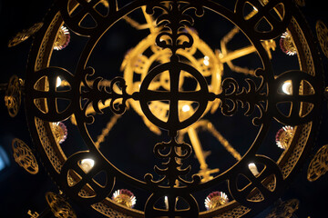 Chandelier in church. Golden chandelier in dark temple. Vintage interior.