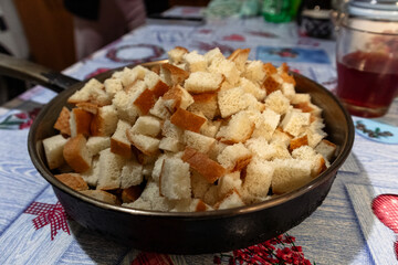 Heap of fried bread in cubes on a pan