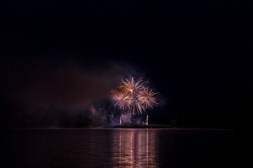 Firework 2023 12 July above bridge of Saint Pardoux Lake in Limousin, Haute vienne, France