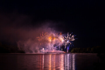 Firework 2023 12 July above bridge of Saint Pardoux Lake in Limousin, Haute vienne, France