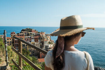Beautiful female model at one of the most colorful villages in Cinque Terre - obrazy, fototapety, plakaty