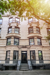 Fototapeta na wymiar a view of a historic brownstone in an iconic neighborhood of Manhattan, New York City