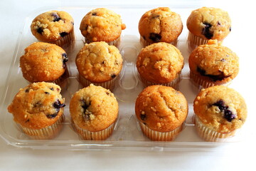  Delicious chocolate blueberry Vanilla muffins in wax liner paper cups isolated on white background,homemade biscuit cakes