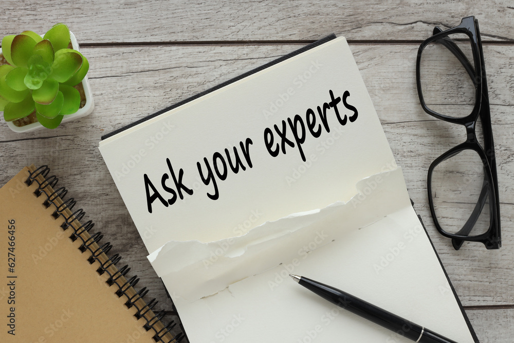 Poster open black notepad with text. pen indicates text ask your expert. view from above
