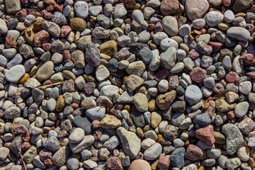 Multi coloured stones texture background. Abstract nature pebbles background or texture. Stone background. Sea pebble beach.