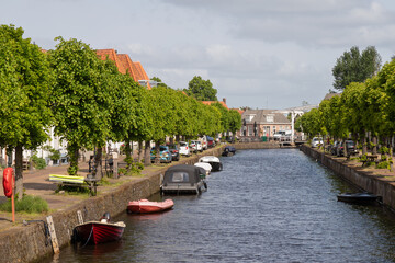 Canal with boats in the historic Dutch city of Hasselt.