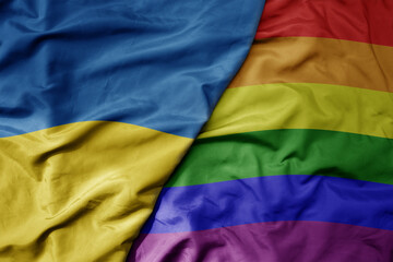 big waving national colorful flag of ukraine and rainbow gay pride flag .