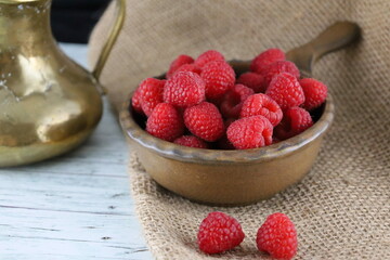 Raspberries in a bowl on the table