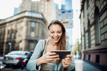 Young woman using a smart phone on a city street in downtown