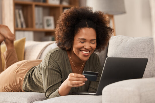 Black woman, credit card and laptop on sofa for online shopping, digital payment and fintech account. Happy female person, computer banking and money for sales, password and ecommerce finance at home