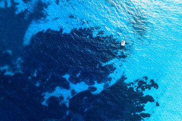 Drone view of a sailing yacht. Luxury transportation. Vacationing people. Vacation and holidays. Summer time for sea travel. The sea bay. Photo for background and wallpaper. Mediterranean Sea.