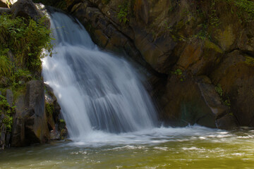 Zaskalnik waterfall at the foot of the mountains, hidden in the forest