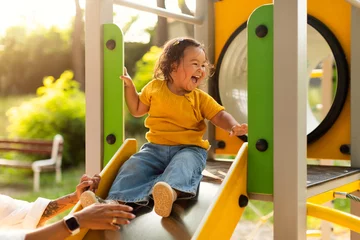 Keuken foto achterwand Amusementspark Adorable Chinese Baby Girl Riding Slides At Playground In Park