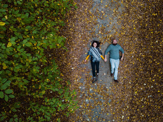 Fototapeta premium Beautiful couple within the colorful autumn forest in Romania