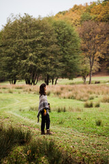 Beautiful female model within the autumn colors forest