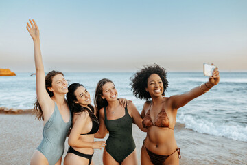 Excited carefree multiracial ladies friends capturing moments spending time together at the beach - Powered by Adobe