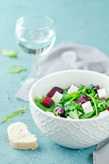 Arugula beet goat cheese salad in a bowl