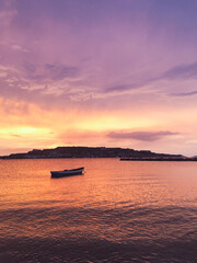 Fish boat at sunset, photo of a fishing boat in an idyllic sunset, in the bay of Playa Lido, Lecher&iacute;a. He closed the hill in the background