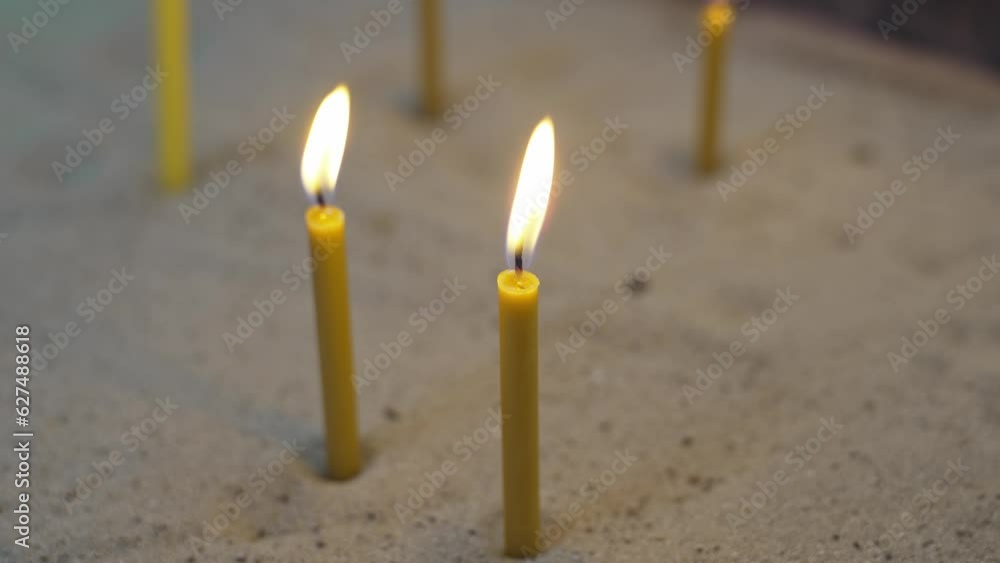 Wall mural Candles set in the sand in the church