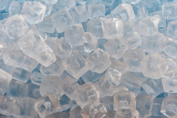 Crystal clear ice cubes, top view, background