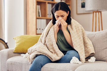 Tissue, blow nose and woman on sofa for home self care with virus, sick and healthcare or...