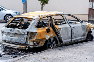The car after the fire. Iron parts of a burnt car. Abandoned burnt-out car, due to a short circuit,...