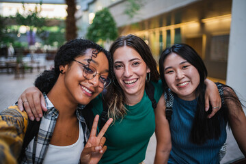 Three college student girls taking a selfie at the university campus during a class break. - Powered by Adobe