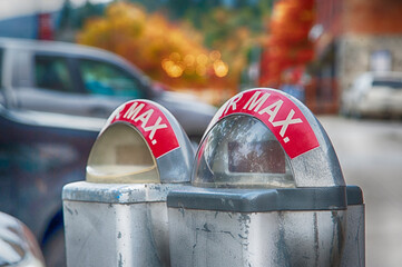 Old and worn parking meters on city street.