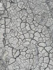 Cracked black dry dirt texture. Natural background
