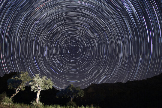 A view of the stars of the Milky Way with a mountain top in the foreground. Night sky nature summer landscape. Perseid Meteor Shower observation