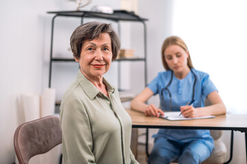 Fototapeta premium Portrait of smiling mature woman after visiting doctor at appointment