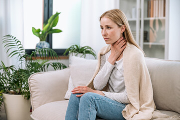 Sick upset woman touching neck and having painful sensations