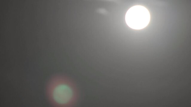Time lapse of night sky with full moon. Full moon in dark night sky. Time lapse of clouds in the night sky.