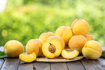 Yellow Peach fruit on wooden basket in garden background, Fresh Yellow Peach.