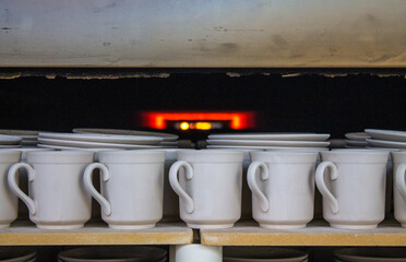 Ceramic white mugs are fired in a muffle furnace at high temperature at a porcelain factory in Likino-Dulevo in the Moscow region