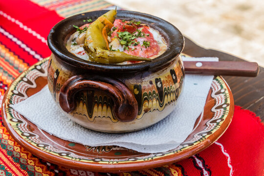 Typical dish of Bulgaria - Gyuveche. Meal baked in a clay pot.