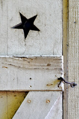 Star-shaped opening in outhouses were used as ventilation and gender identifier “for Men” in bygone era.  Hook and eye lock keeps door closed when not in use