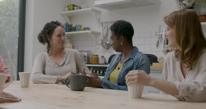 Group of Female Friends Community Talking at Kitchen Table