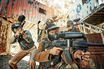 Paintball team, gun and people aim, focus or shooting at target, training or battlefield conflict, fight or army practice mission. Military, match game or group point weapon in war, action or battle