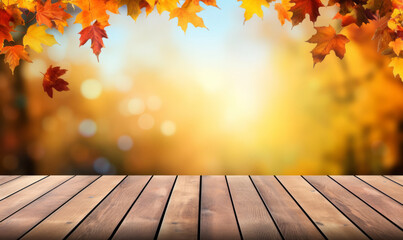 Naklejka na ściany i meble Empty wooden table with fall leaves, glowing sun and blurry seasonal colors. Autumn copy space background.